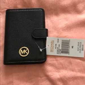 MICHAELMichael Kors passport cover blank and gold.